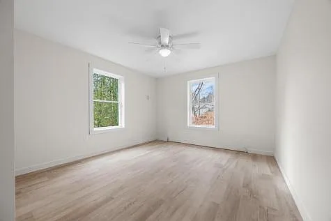 Spacious, bright bedrooms with large windows, closets, ceiling fan with light, easy to clean vinyl plank flooring and HWBB heat