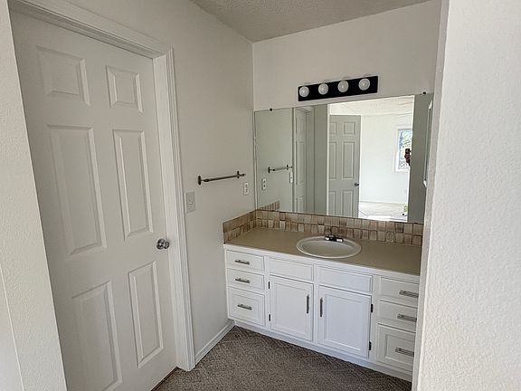 Sink area in primary bedroom. The door is the door to the bathroom.