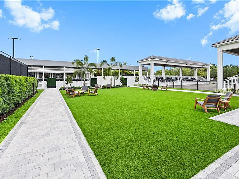 Yet to be furnished gathering area between pickle ball stadium/clubhouse and new tennis facility.