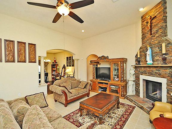Large family room with stone fireplace recently added by owner.