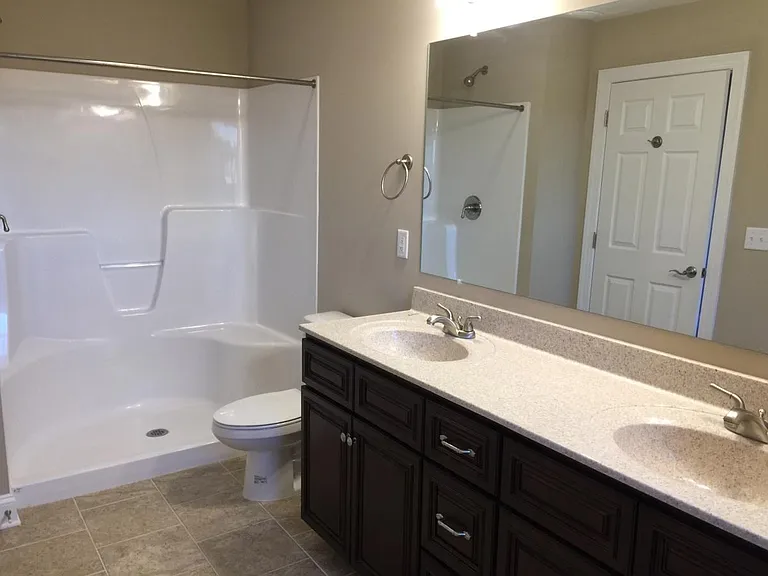 Master bath with double sink vanity and large walk-in shower