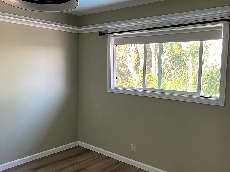 Bedroom number 3. With a pretty view of the canyon. Each bedroom has curtain rod and room darkening shades and ceiling fan.