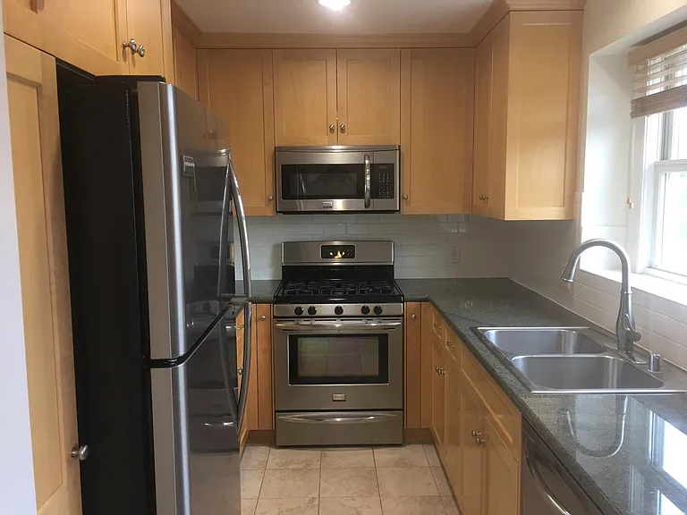 Full kitchen with large frig, lots of counterspace, window over the sink and dishwasher.