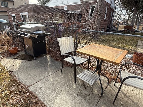 Table and gas grill in shared yard