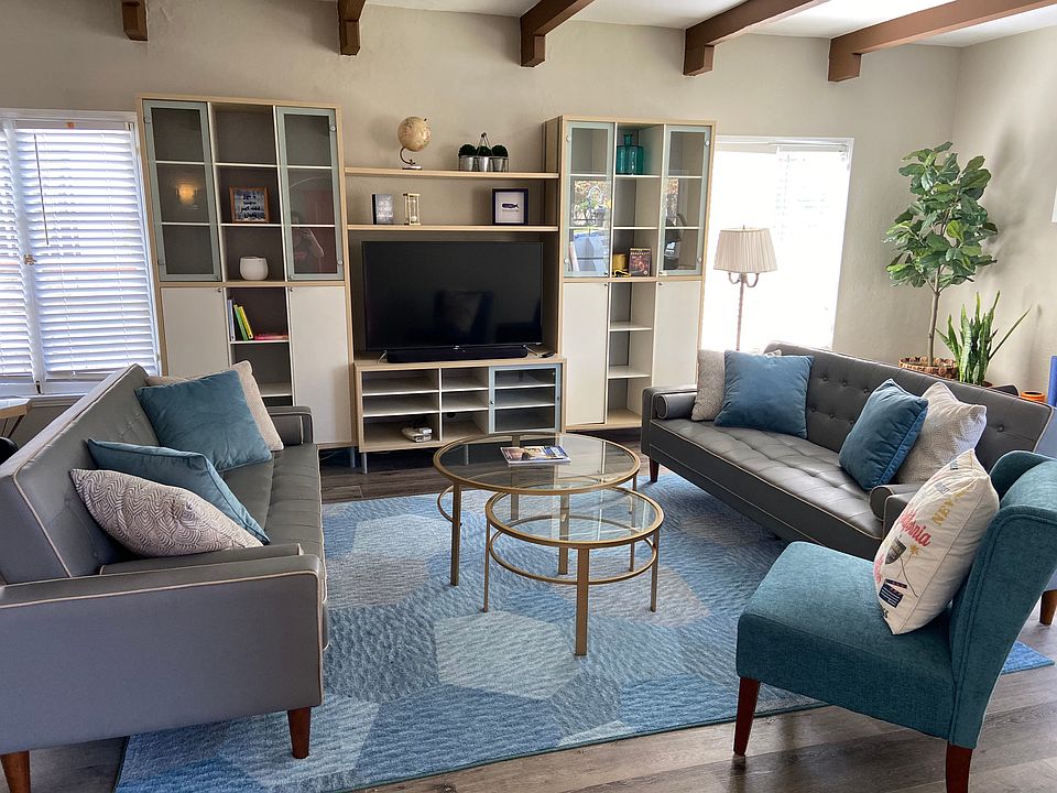 Large living room with TV and storage.