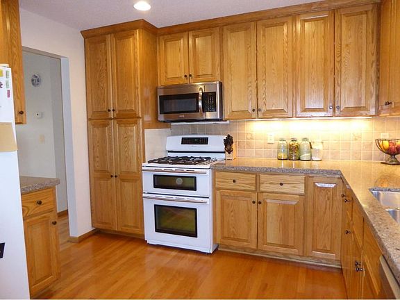 HEART OF THE HOME Roomy granite kitchen is open to dining & deck.