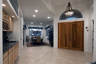 Beautiful front door and dramatic ceilings.