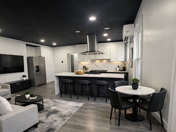 Island kitchen with quartz countertops and seating