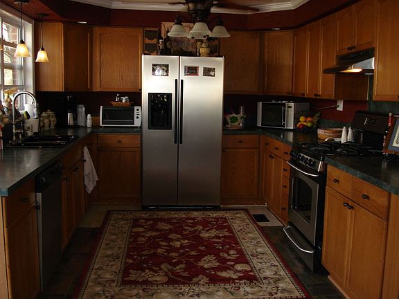 Upgraded Kitchen with Stainless Refrigerator and Gas Stove