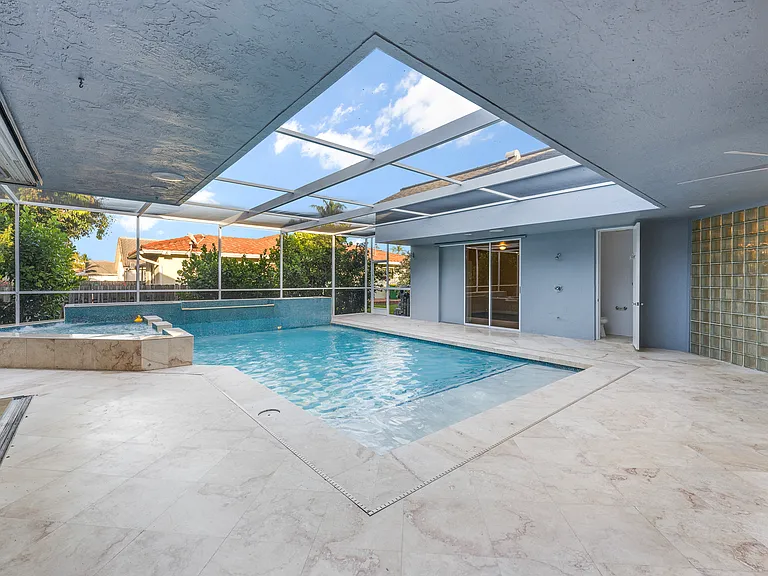 Rare courtyard design with direct pool access and views from throughout the home.