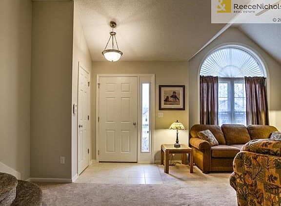 Tile entry.  Half round window and vaulted ceiling adds character to the room.