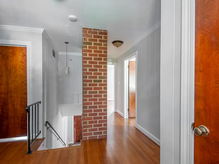 Upstairs hallway with exposed brick