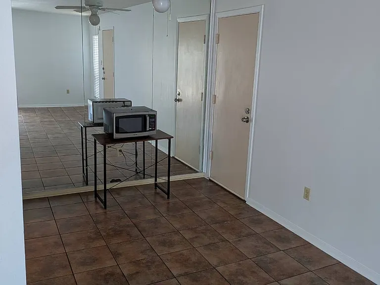 Photo taken from living room facing into dining area. We furnish microwave. Some are installed in the kitchen and some are on table or countertop.