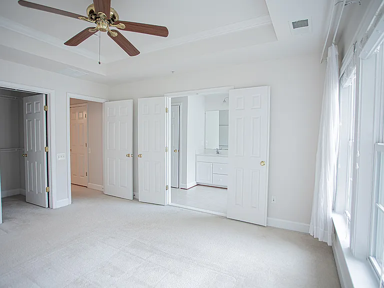 Master Bedroom featuring en suite bathroom and a good size walk-in closet