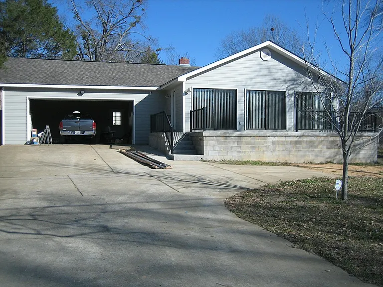 front of house with garage door open