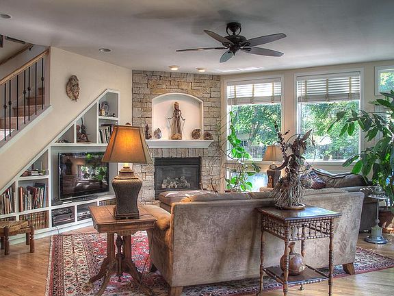 Family room with fireplace and media center including TV and sound system.