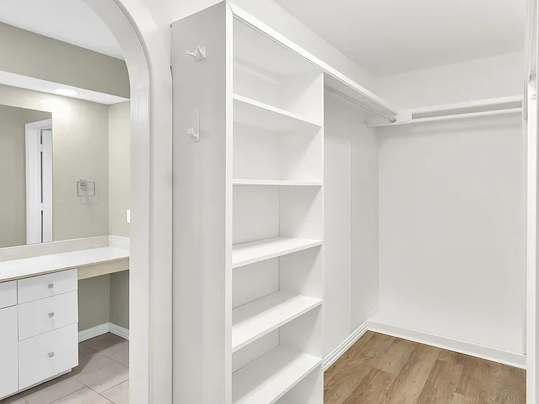 Primary bedroom walk in closet.