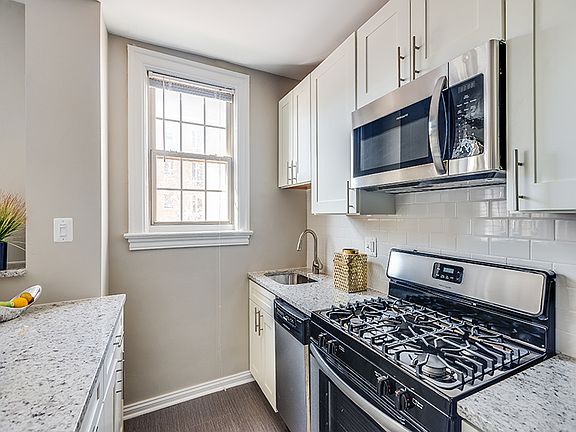 Renovated kitchen with granite countertops and stainless steel appliances