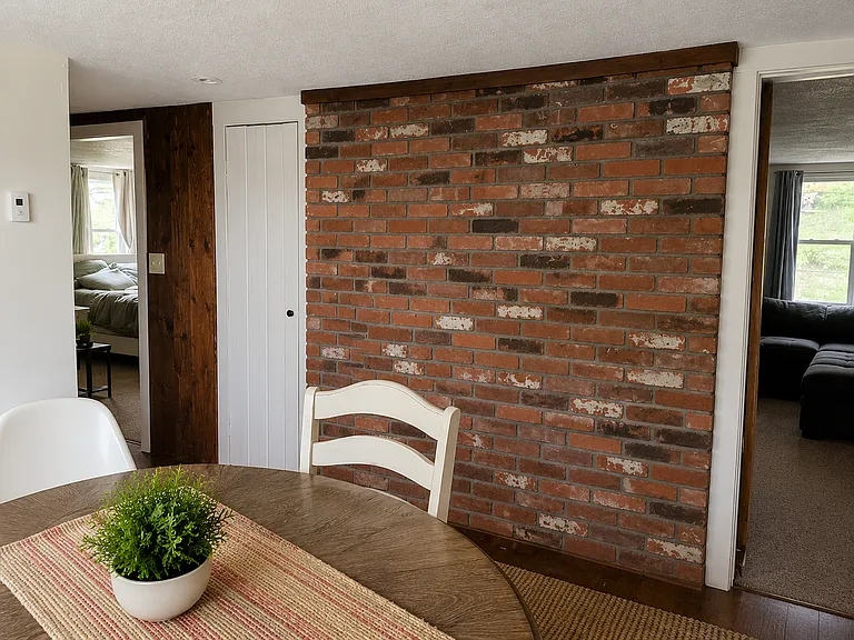A decorative brick wall adorns the dining room space. (AI Generated for Scale.)