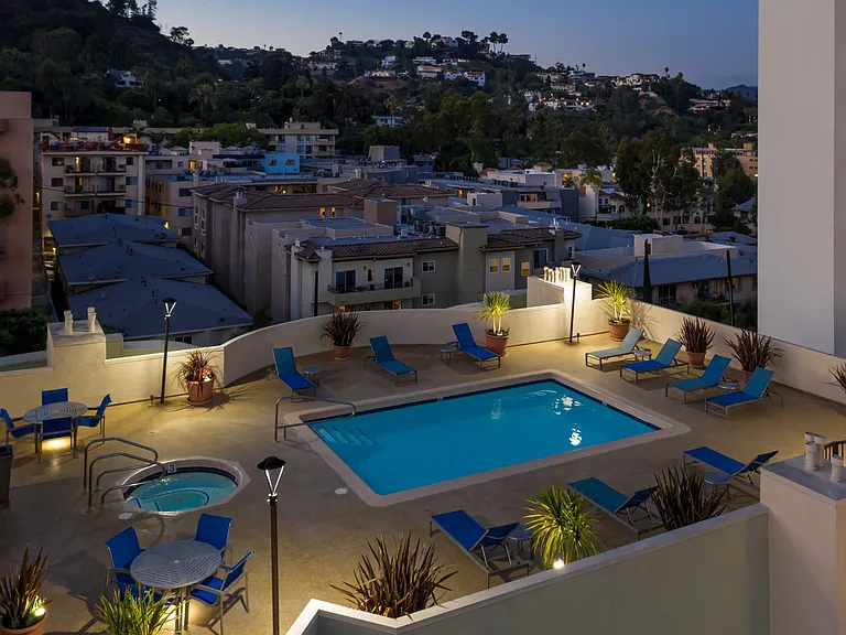 Apartments in Hollywood, CA - Elevated Night Time View of Pool, Jacuzzi, Patio with Lounge Chairs and Tables with view of Surrounding Areas summit.