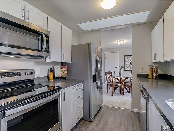 Refreshed Kitchen with solid quartz counters, new flooring, new SS sink and new suite of Stainless Steel Appliances.  $4200 Appliance upgrade! 