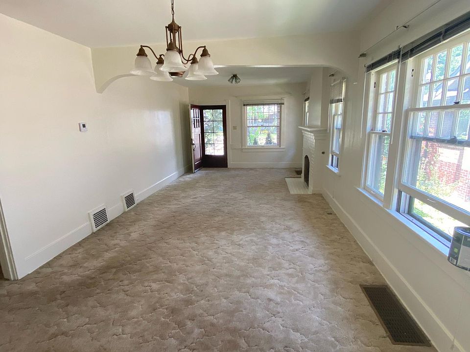 Living room and dining room looking from kitchen to front entrance.