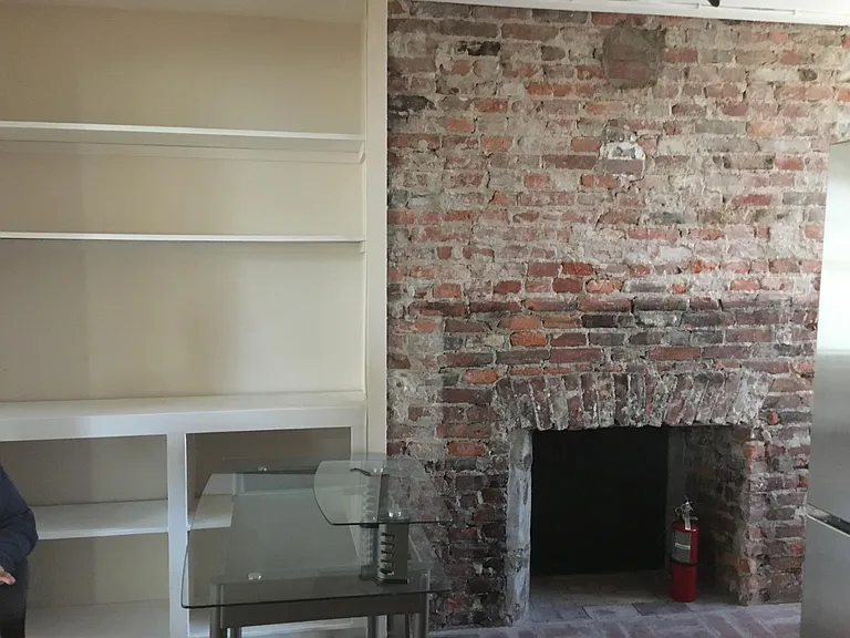Builtins and exposed brick wall in kitchen