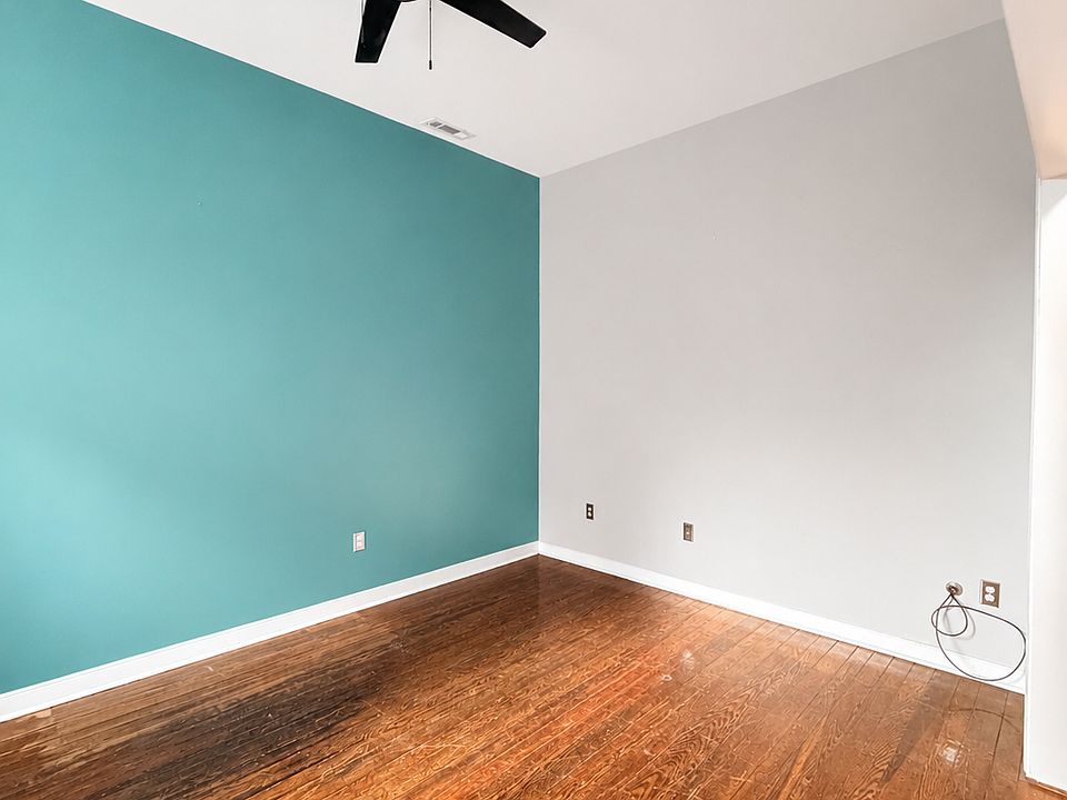 Bright second room with high ceilings, beautiful hardwood floors, a ceiling fan, and great natural light. Great for an office, living room, or second / guest bedroom space.