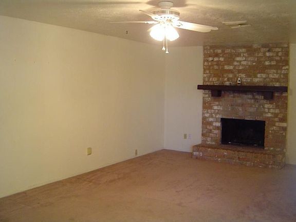 Another view of living room area with brick fireplace