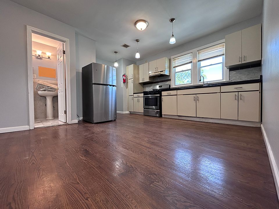 Modern Kitchen with granite countertop, hardwood floors and plenty of modern cabinets including a large pantry cabinet