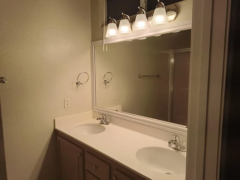 Master Bathroom has Dual Sinks, Stylish Lighting and Walk-in Shower.