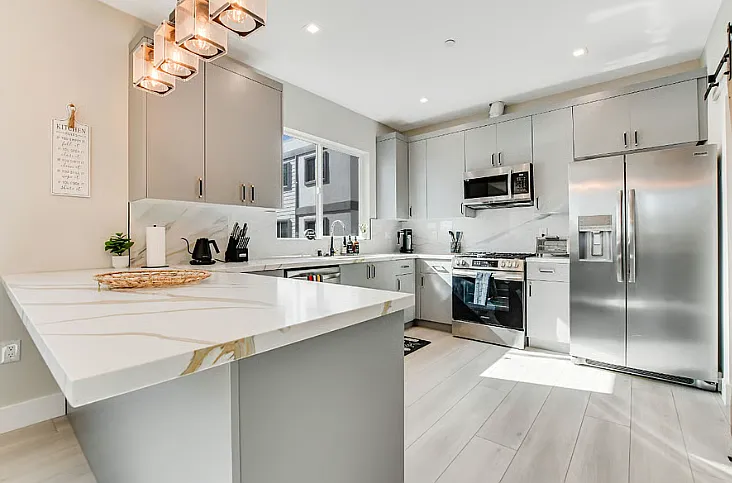 Modern kitchen with sleek finishes, ample counter space, and fully equipped essentials for everyday convenience.