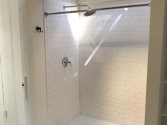 huge shower with new tile and skylight