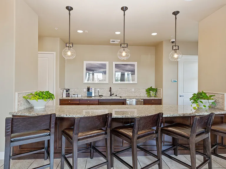 The clubhouse includes a bar area, movie theatre, and tech lounge with free Wi-Fi and charging stations