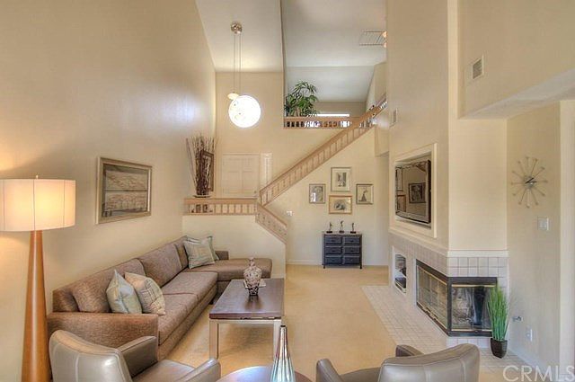 This is a GREAT room...multiple seating areas, fireplace and DRAMA!
