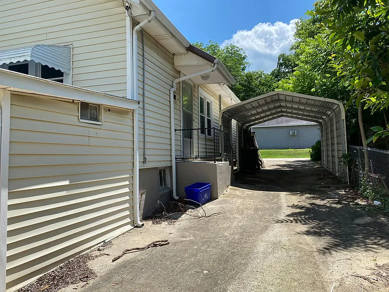 Long private driveway provides off street parking for a minimum of 2 cars, side entrance to kitchen for easy grocery unloading.