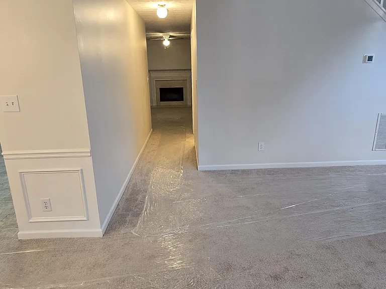 Hallway from living room to den area and half bath and laundry