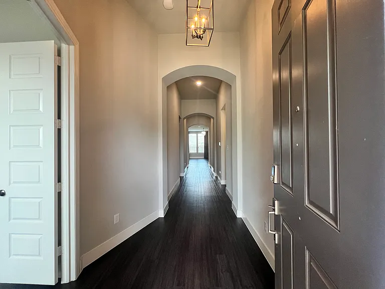 Entry hall with architectural details and high ceilings.