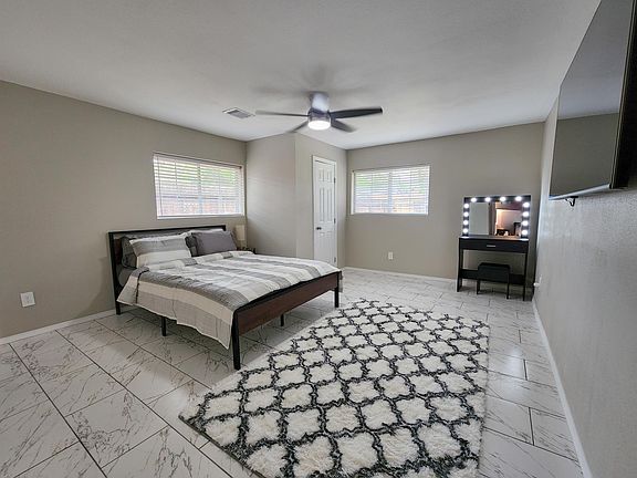 Primary Bedroom with Make up Vanity, 65 inch Amazon Smart TV and attached master bathroom.