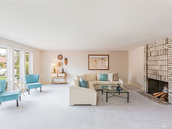 This open living room is complete with a wood burning fireplace.