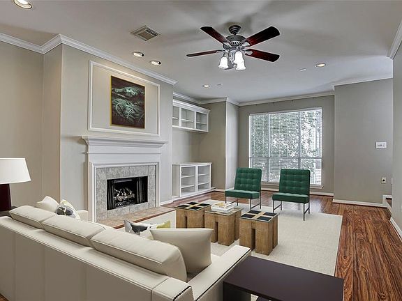 Impressive second floor living room has crown moulding, recessed lighting, built-in media shelving, new laminate floors, and over-sized windows. Virtually staged.
