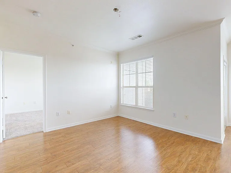 Apartment living room with wood style floor.