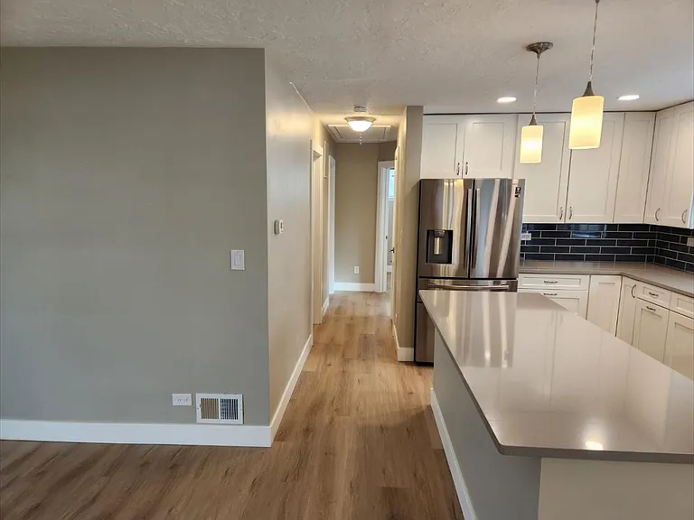 Hallway to 3 bedrooms and bath