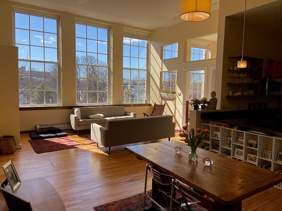 Dining room and living room. 5 massive nearly floor to ceiling windows! 14 foot ceilings!