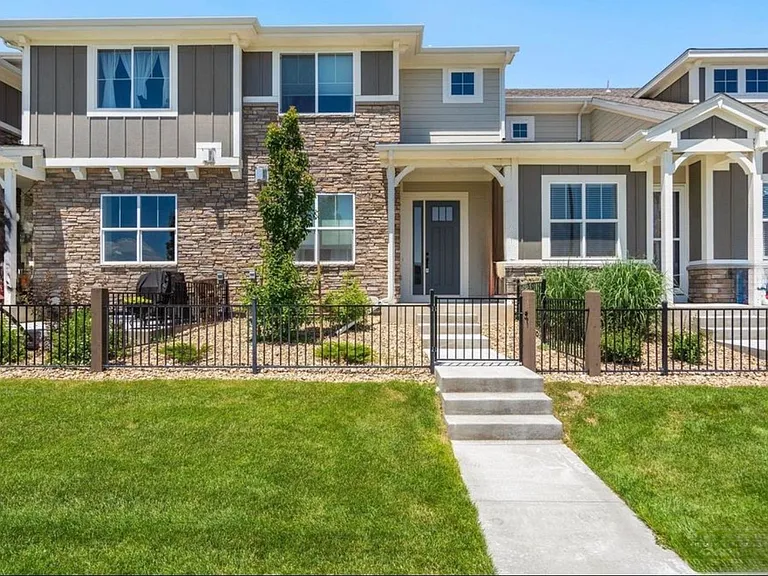 Front door w/ low maintenance front fenced courtyard. View from street.