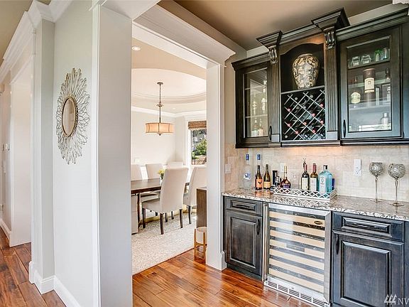 Decadent Butler's pantry/Entertainment bar complete with wine cooler, wine rack, dish storage, and bottle storage