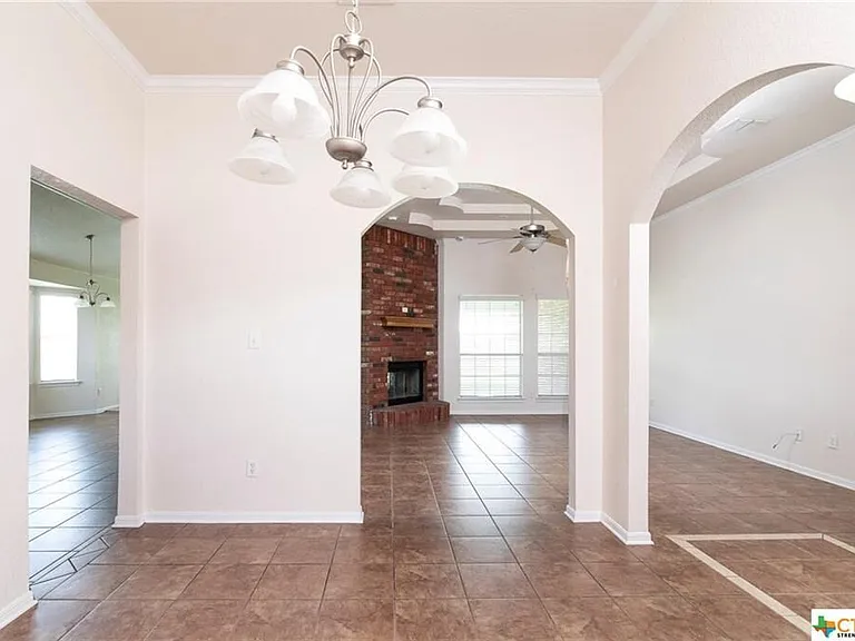 Formal dining room with arched doorways.