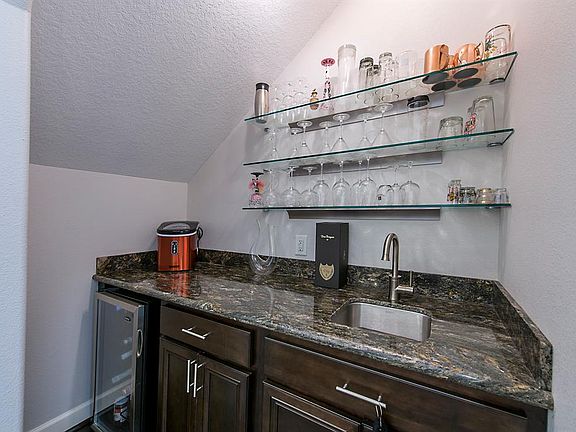 Custom wet bar area under the stairs.