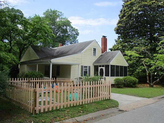 Side door w/ screened-in porch, carport and pet pen.