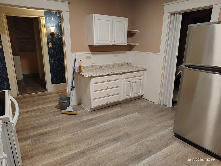 Kitchen, looking South/East. 2nd set counter/cabinets, Laundry room next to Fridge.